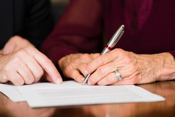 Woman signing estate planning documents
