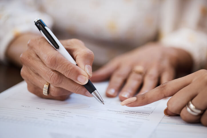 Woman working on estate planning documents with attorney