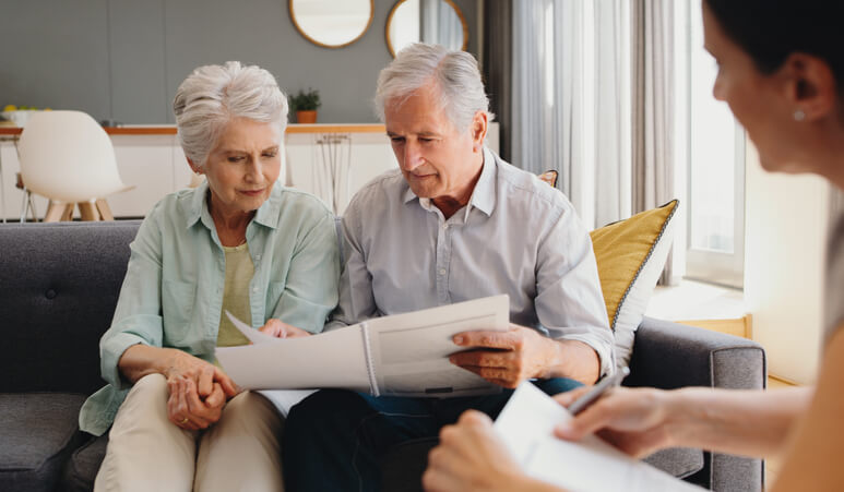 Older couple sitting with estate planning attorney