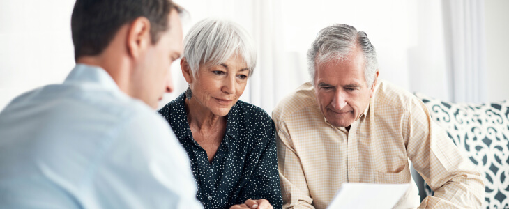 Elderly couple speaking with attorney