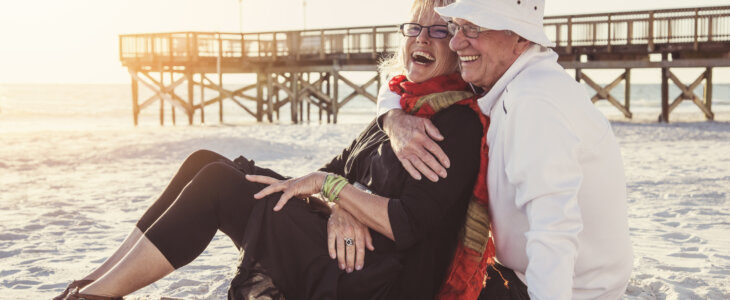 Senior couple sitting on a beach