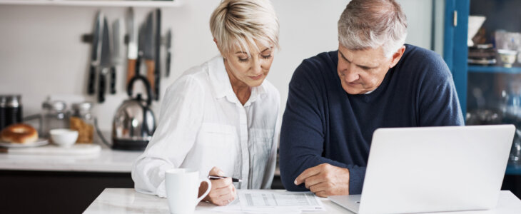 Shot of a mature couple using their laptop