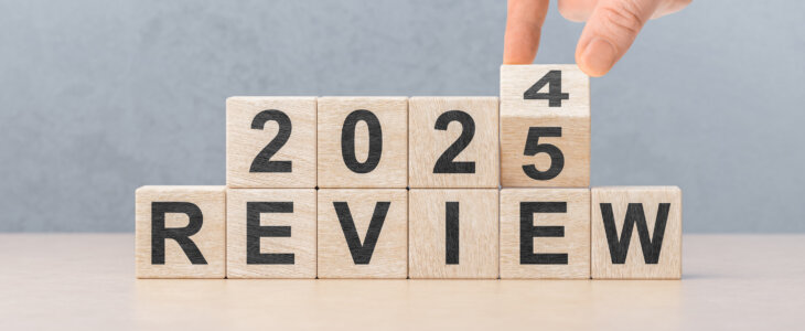 Review 2025. hand flips wooden cube and changes words REVIEW 2024 to REVIEW 2025. Business 2025 review new year concept. Economy and business.