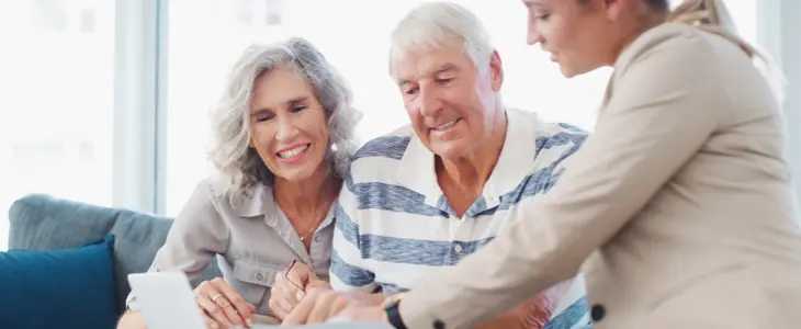 older couple looking over documents with a third person