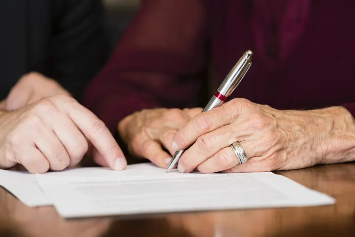 Woman signing estate planning documents
