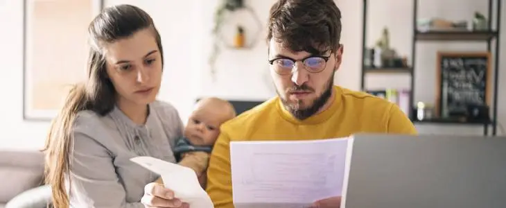 Young father and heir to an estate, looking at overdrafted bills