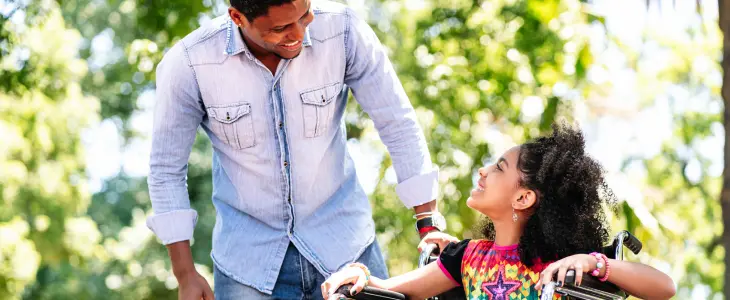 Father looking at daughter in wheelchair